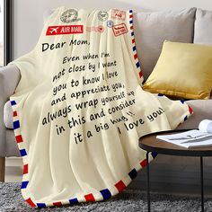 a blanket that says dear mom on it