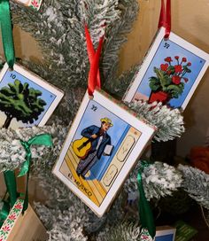 three tarot cards are hanging from a christmas tree