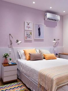 a bed room with a neatly made bed next to a wall mounted air conditioner