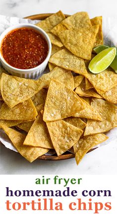 crispy air fryer tortilla chips on a plate with salsa and lime