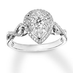 a pear shaped diamond engagement ring on a white background