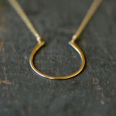 Hand-forged and hammered, this horseshoe of 14k gold filled has a nice size and a pretty finish for a lifetime of wear and love... and good luck! It is hung from a 14k goldfill chain and lends itself nicely to both dressing up and everyday wear. The horseshoe pendant measures approximately one inch long. Each horseshoe is handcrafted individually, so you can expect some slight variation from the piece pictured. Choose your necklace length from the drop-down menu. Classic Yellow Gold Horseshoe Jewelry, Gold Horseshoe Necklace For Good Luck, Classic Horseshoe Gold Necklace, Everyday Gold Horseshoe Necklace, Gold Horseshoe Jewelry For Anniversary, Classic Horseshoe Jewelry As A Gift, Gold Horseshoe Necklace For Formal Occasions, Formal Gold Horseshoe Necklace, Horseshoe Necklace Gold