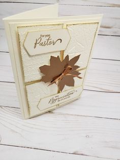 a white card with a brown leaf on it and the words for you father written in gold