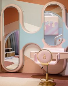 a mirror and chair in front of a wall with mirrors on it's sides