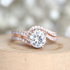 a close up of a ring on top of a piece of wood