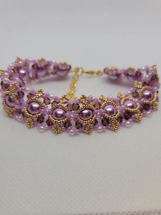 Beautiful and eye catching! This substantial bracelet warms quickly to your body temperature.  I'm going to call it lavender hue, and overall, that's the color you see, but so many colors come into play. Perfect for an evening out with friends or that special someone.  8mm lavender pearl beads 4mm dark purple czech bicone crystals 3mm white pearl beads 11/0 lavender seed beads 15/0 yellow gold seed beads Lobster clasp Extension chain Even though this bracelet is a bit longer, you need the extra Elegant Purple Hand-strung Bracelets, Elegant Purple Beaded Crystal Bracelet, Lavender Beaded Bracelet Jewelry, Elegant Purple Crystal Bracelet With Spacer Beads, Handmade Purple Crystal Bracelet With Round Beads, Handmade Purple Crystal Bracelet, Handmade Lavender Bracelets, Elegant Purple Beaded Bracelet With Colorful Beads, Elegant Beaded Lavender Bracelets