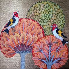 two birds sitting on top of a tree next to red and yellow flowers with green leaves