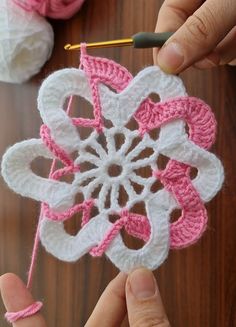 someone is crocheting a flower with yarn