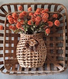 a wicker basket with flowers in it