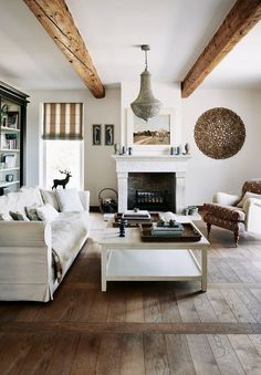 a living room filled with furniture and a fire place in the middle of a room