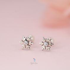 Let's add a touch of elegance to your jewelry collection with these stunning snowflake screw-back stud earrings. Made with solid 925 sterling silver and sparkling cubic zirconia stones, they can be worn in various positions, including the cartilage, and are comfortable even while sleeping. These charming, delicate earrings are sure to make a perfect gift for your loved one or a lovely addition to your everyday wear. Sold as a pairPost length is about 8 mmMaterials: 925 sterling silverFinish: platinum plateDimensions: 0.19 x 0.19 inGauge: 23 (0.6 mm) Jewelry Care: See more information about how to care for your jewelry here. Shipping Policy: Orders will be shipped within 1-3 business days. Economy shipping will take 7-14 days to arrive and standard shipping is 1- 4 days for U.S. orders. Int Sterling Silver Piercings In Diamond White As Gift, Silver Diamond Cartilage Earrings As Gift, Silver Snowflake Cubic Zirconia Earrings, Silver Snowflakes, Sterling Silver Stud Earrings, Silver Stud Earrings, Delicate Earrings, Screw Back Earrings, Sterling Silver Studs