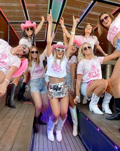 a group of young women standing on top of a boat