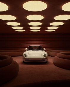 a white car is parked in the middle of a room with round lights above it