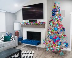 a living room with a christmas tree in the corner and a flat screen tv mounted on the wall