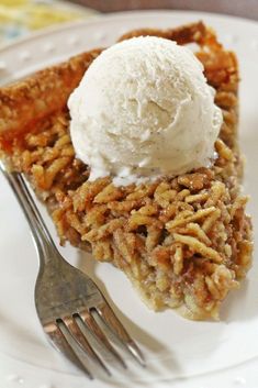 a slice of pecan pie with ice cream on top and a fork next to it