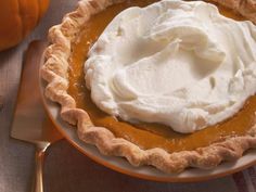 a pumpkin pie with whipped cream on top