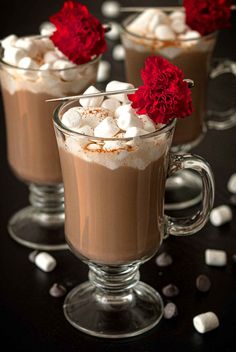 two glasses filled with hot chocolate and marshmallows