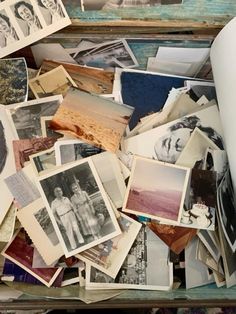 an old box filled with pictures and papers