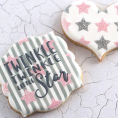 two decorated cookies with words and stars on them