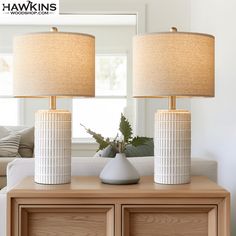 two lamps sitting on top of a wooden table