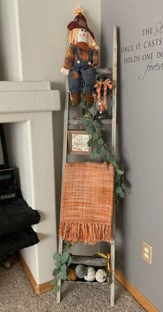 an old ladder is used as a shelf for stuffed animals and other things to display