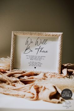 a mother's day sign sitting on top of a bed next to a blanket