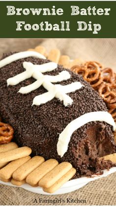 brownie batter football dip on a plate with pretzels