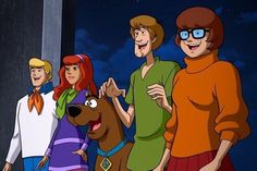 the scooby gang is standing next to each other