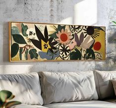 a painting hanging on the wall above a couch