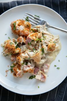 a white plate topped with food and a fork