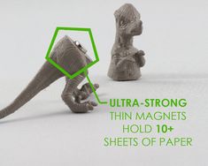 an image of two dinosaurs that are made out of paper with the words ultra - strong thin magnets hold 10 sheets of paper