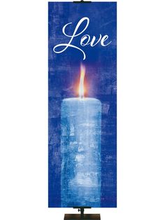 a candle with the word love on it is lit in front of a blue background