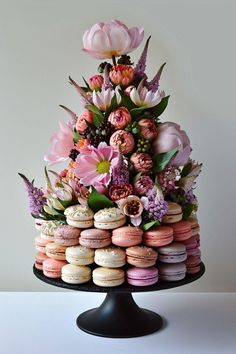 there is a cake made out of macaroons and flowers