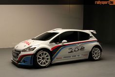 a white car with red, blue and orange stripes on it's side parked in a garage