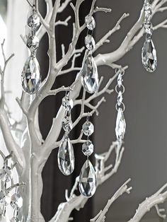 a white tree with crystal drops hanging from it's branches