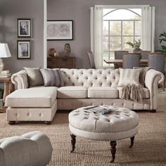 a living room filled with lots of furniture and decor on top of carpeted flooring