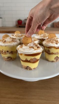 a person picking up some desserts on a plate