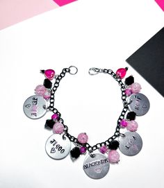 Blackpink bracelets with all the girl's stamped names, I colored their names with black and pink lettering. The bracelet has black and pink beads with cracked glass, pink marbled beads, and black crystals. I used black chain and hearts to represent their light sticks. The middle says Blackpink with a crown stamp. Show off your ultimates with this Blackpink bracelet, it is a must have for all Blinks. Due to the handmade nature of this product, there may be slight variations in charms and beads de Blackpink Bracelet, Blackpink Jewelry, Blackpink Merch, Pandora Black, Pink Pens, Blackpink Blink, Black Chain, Pink Beads, Pink Bracelet