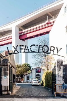 a car is parked under an overpass with the word lxfactory on it