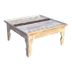 an old wooden table with ornate carvings on it's legs and top, sitting against a white background