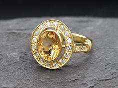 Gold Citrine Ring set with a Natural Citrine in a diamond cut, flawless clarity & yellow colour, from Brazil, at 10x8mm, 3 Carats. With small CZ Diamonds around. Antique Ring design made of Gold Vermeil ☞ thickest 18k Gold Plating on top of Solid 925 Sterling Silver ☞ made to last. Matching Pendant: www.etsy.com/listing/946991700 Matching Earrings - please ask me November Birthstone - Genuine & Natural Stones❀ ⌛Last Rings left ⌛ ☞ Choose your size ☞ I resize (before shipping) for FREE to Any siz Oval Yellow Sapphire Topaz Ring For Formal Occasions, Oval Yellow Sapphire Topaz Ring For Wedding, Yellow Oval Topaz Ring With Halo Setting, Yellow Oval Topaz Ring With Center Stone, Fine Jewelry Yellow Oval Topaz Ring, Oval Yellow Topaz Ring With Accent Stones, Yellow Oval Topaz Ring With Accent Stones, Yellow Oval Topaz Ring Hallmarked, Natural Emerald Rings