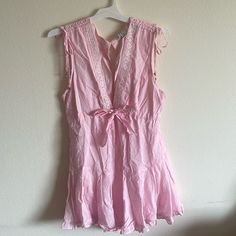 Pink Low Cut Romper With Slight Open Back And Ruffles Sleeveless Lace Trim Jumpsuit, Summer Beach Jumpsuits And Rompers With Lace Trim, Chic Spring Jumpsuits And Rompers With Lace Trim, Feminine Sleeveless Jumpsuits And Rompers For Spring, Feminine Summer V-neck Jumpsuits And Rompers, Feminine V-neck Jumpsuits And Rompers For Summer, Feminine V-neck Summer Jumpsuits And Rompers, Feminine Sleeveless Jumpsuits For Spring, Feminine V-neck Jumpsuits For Summer