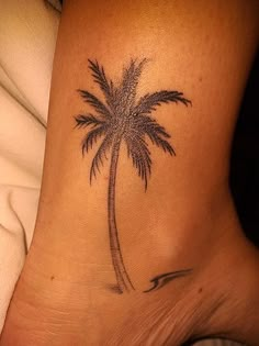 a small palm tree tattoo on the ankle