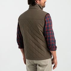 Description Our Waxed Duck Canvas Vest pays tribute to our storied heritage as America's original canvas clothier, dating back to 1865 when our founders repurposed surplus army tent material into durable workwear garments. This vest embodies that legacy with a modern twist, combining rugged functionality with timeless style. Crafted from durable duck canvas, the vest features a waxed treated, water-repellent finish that ensures protection against the elements, making it ideal for outdoor pursuits and everyday wear. The Primaloft insulated quilted construction and performance flannel lining provide additional warmth. Embodying Duck Head's commitment to quality craftsmanship, the vest is meticulously detailed with reinforced stitching and YKK hardware, ensuring durability and longevity. Deta Outdoor Military Vest For Fall, Fall Outdoor Military Vest, Military Style Outdoor Vest For Fall, Military Style Vest For Outdoor Fall Activities, Military Vest For Outdoor Activities In Fall, Military Vest For Fall Outdoor Activities, Rugged Cotton Outerwear For Outdoor Activities, Rugged Cotton Hunting Outerwear, Brown Cotton Hunting Outerwear