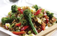 a white plate topped with broccoli and other vegetables