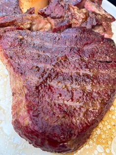 a large piece of meat sitting on top of a white plate