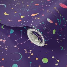 a black background with stars, planets and moon prints on the fabric in different colors