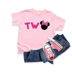 a pink t - shirt with minnie mouse on it, jeans and converses are shown