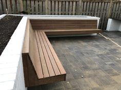 a wooden bench sitting on top of a brick patio