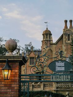 the entrance to disneyland's halloween mansion is lit up